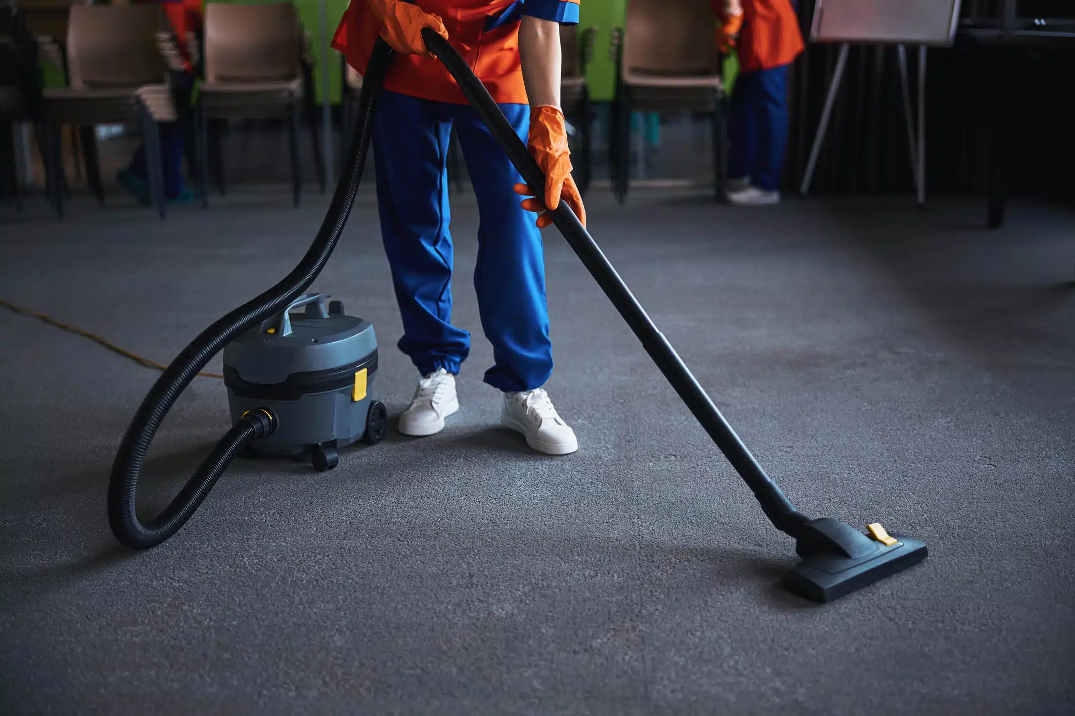 Person using a vacuum cleaner in a commercial facility