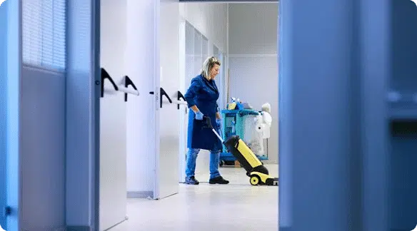 Janitor vacuuming in an office facility