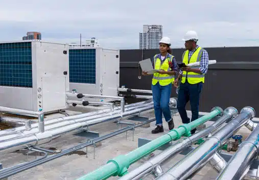 Two engineers talking on a facility roof