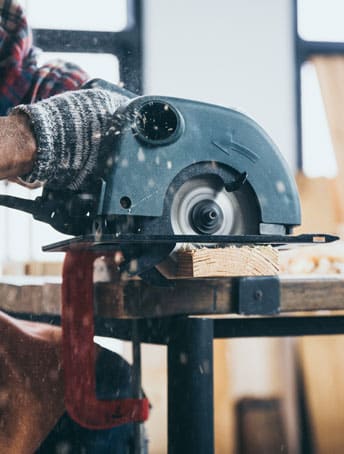 Saw cutting into wood